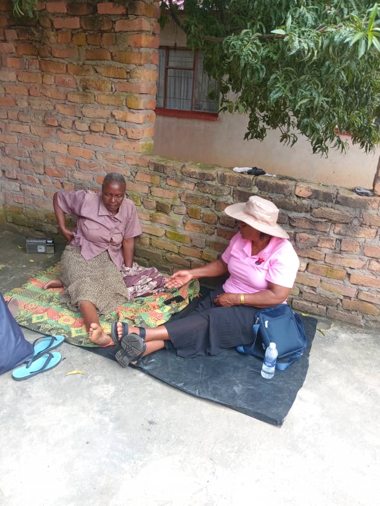 A caregiver offering psychosocial support to an elderly resident